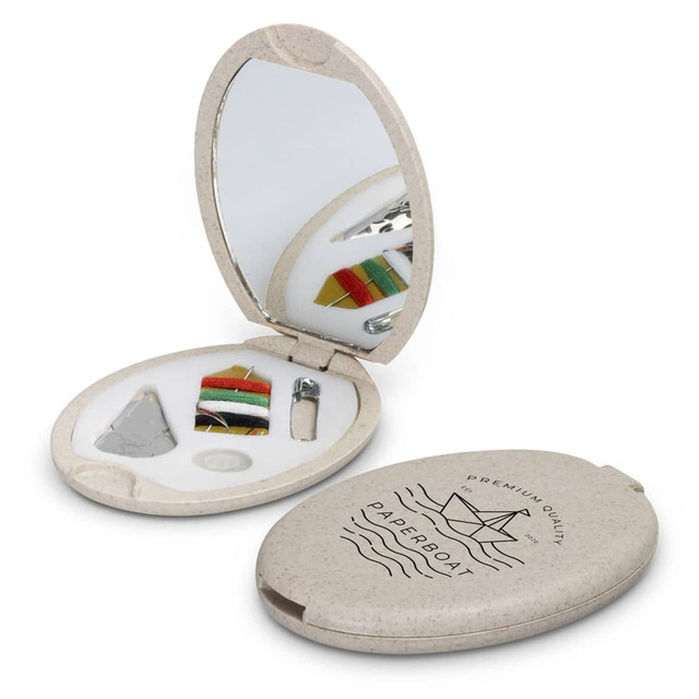 A compact sewing kit featuring a mirror, threads, needles, and accessories in a beige case with a logo. A compact sewing kit featuring a mirror, threads, needles, and accessories in a beige case with a logo.