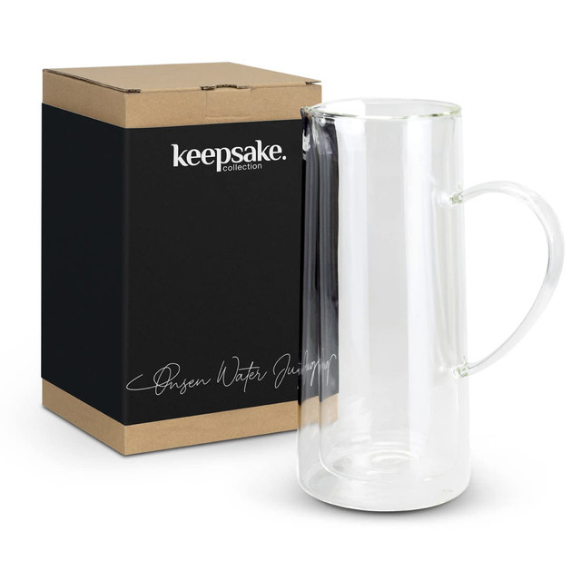 A glass water jug with a handle, alongside its sleek black packaging featuring a logo. A glass water jug with a handle, alongside its sleek black packaging featuring a logo.