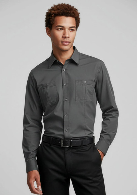 A long sleeve button-up shirt in grey with two front pockets and a logo, paired with black trousers.