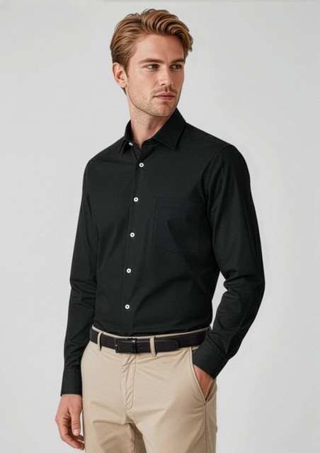 A black long sleeve button-up shirt on a model, paired with beige trousers, featuring a subtle logo.