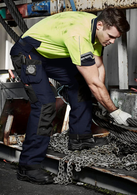 Men's ultralite multi-pocket pants in navy with multiple pockets, worn by a man in a high-visibility shirt. Men's ultralite multi-pocket pants in navy with multiple pockets, worn by a man in a high-visibility shirt.