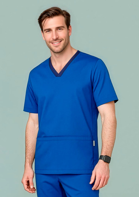 A man wears a vibrant blue scrub top with a V-neck design and a logo on the pocket.