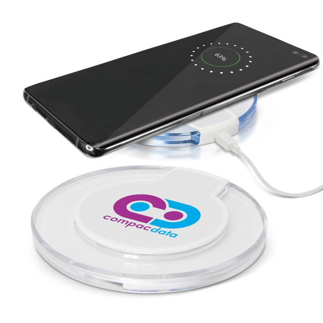 A wireless charger in clear casing with a smartphone placed on top, featuring a logo on one side. A wireless charger in clear casing with a smartphone placed on top, featuring a logo on one side.