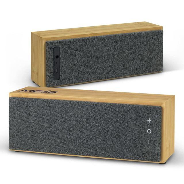 A bamboo Bluetooth speaker with a grey fabric front and side control panel. It features a logo on the top. A bamboo Bluetooth speaker with a grey fabric front and side control panel. It features a logo on the top.