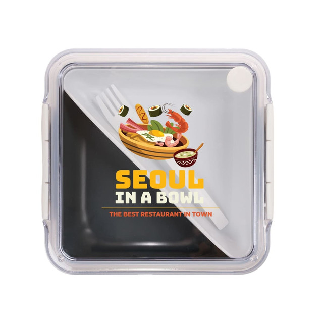 A clear square lunch box with a graphic design featuring food items and a logo. Fork and spoon included inside.