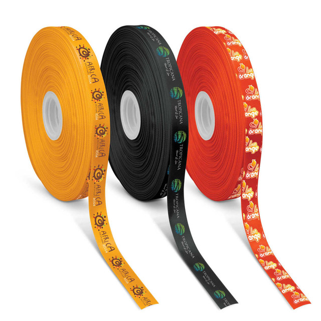 Three spools of personalised ribbon in orange, black, and yellow, each with varied printed designs and logos. Three spools of personalised ribbon in orange, black, and yellow, each with varied printed designs and logos.