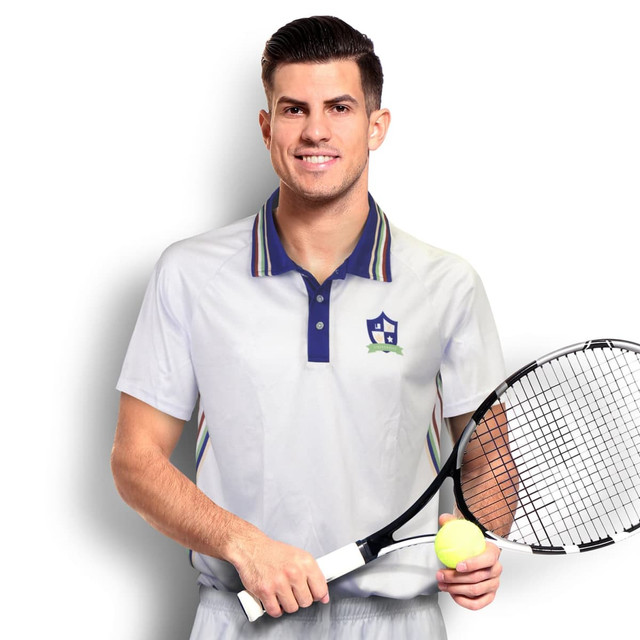A man wearing a custom men's tennis top in light grey with a collar and stripes, holding a tennis racket and ball. A man wearing a custom men's tennis top in light grey with a collar and stripes, holding a tennis racket and ball.