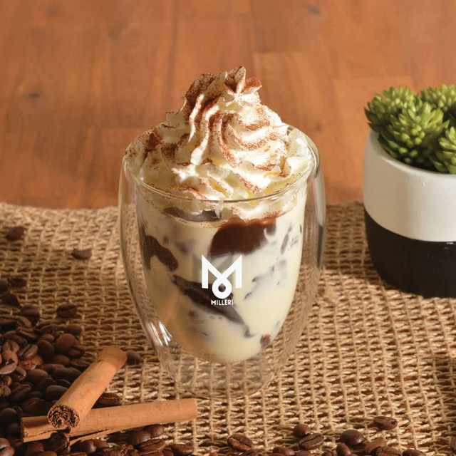 A drink cup with a double wall design, showcasing a dessert topped with whipped cream, set on a rustic table. A drink cup with a double wall design, showcasing a dessert topped with whipped cream, set on a rustic table.