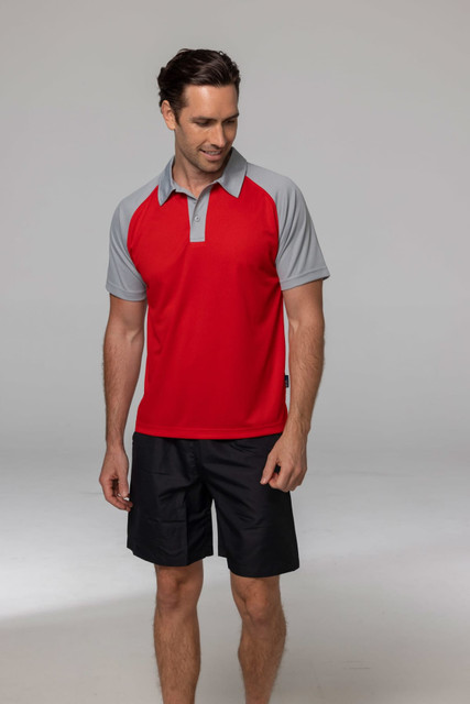 A man wearing a red and grey polo shirt paired with black shorts, smiling against a neutral background. A man wearing a red and grey polo shirt paired with black shorts, smiling against a neutral background.