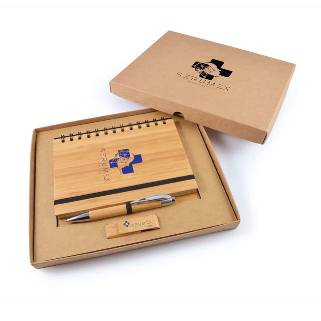 A bamboo notepad with a pen in a cardboard gift box, featuring a logo on the items and box. A bamboo notepad with a pen in a cardboard gift box, featuring a logo on the items and box.