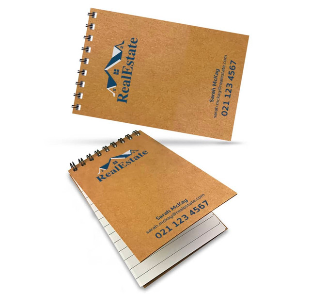 Aspiral-bound A7 notebook with a natural kraft cover and branding, featuring blank pages inside. Aspiral-bound A7 notebook with a natural kraft cover and branding, featuring blank pages inside.