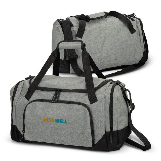 A grey duffle bag with black accents featuring a logo, detailed with dual handles and an adjustable shoulder strap. A grey duffle bag with black accents featuring a logo, detailed with dual handles and an adjustable shoulder strap.
