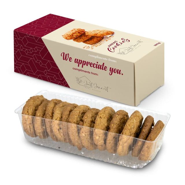 A boxed cookie pack featuring a clear container of golden-brown cookies arranged neatly inside.