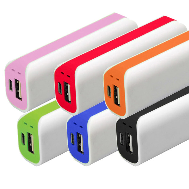A collection of six curved power banks in pink, red, orange, green, blue, and black, featuring USB ports and a logo. A collection of six curved power banks in pink, red, orange, green, blue, and black, featuring USB ports and a logo.