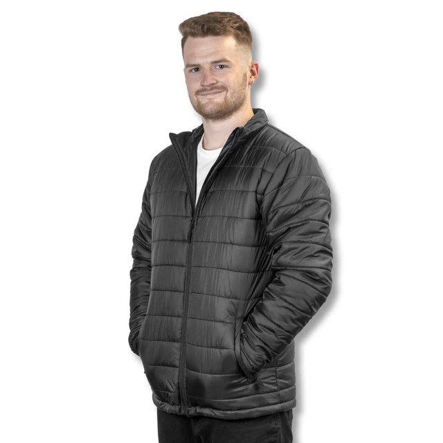 A unisex black puffer jacket with a zip front and pockets worn by a model against a plain background. A unisex black puffer jacket with a zip front and pockets worn by a model against a plain background.