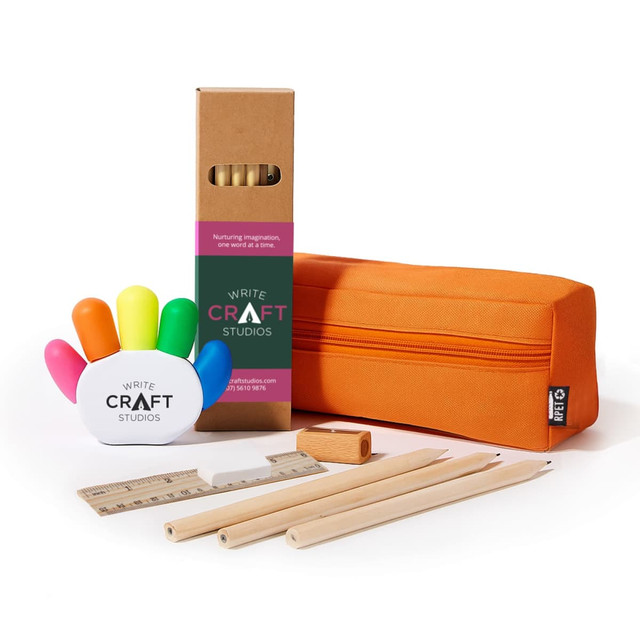 An orange pencil case contains wooden pencils, a ruler, a sharpener, and a white hand-shaped holder with colourful markers.