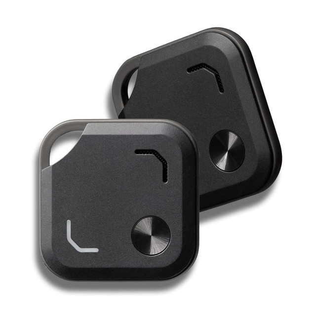 Two black VibeTag Bluetooth trackers with a sleek design, featuring a circular button and a logo on one side.
