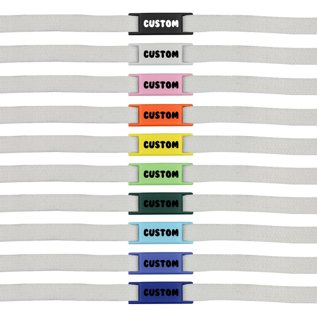 A row of white shoelaces featuring various coloured luxury shoelace charms in multiple designs and shades.