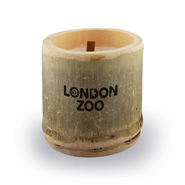 A bamboo candle with a wooden wick, featuring a natural finish and a logo on the front.