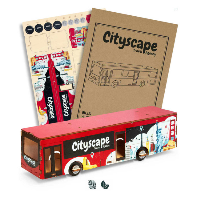 A model bus in red and white featuring cityscape graphics, accompanied by design templates and a booklet.