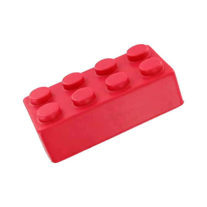 A red rubber stress block shaped like a building block, featuring rounded knobs on top. It has a simple design and a logo.