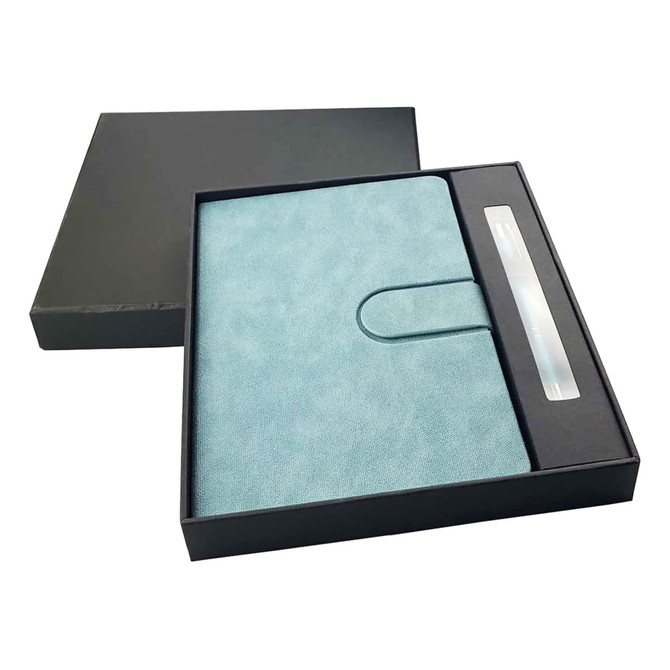 A turquoise notebook with a pen, presented in a black gift box. The notebook features a clasp closure.