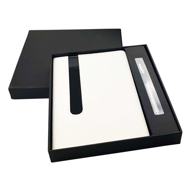 A white notebook with a black strap and a matching pen, packaged in a sleek black gift box.