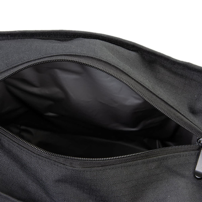 A black cooler bag with a zipped opening, featuring a smooth, insulated inner lining.