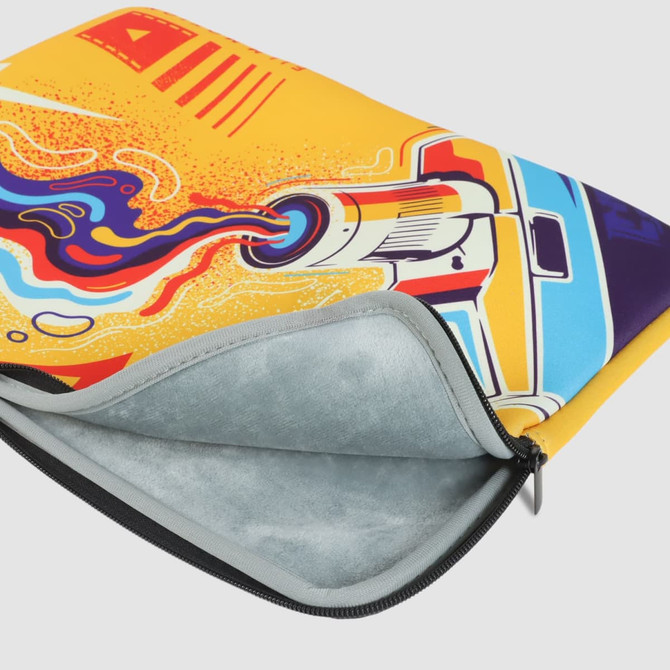 A medium laptop sleeve featuring a vibrant yellow design with abstract graphics and a logo. The interior is grey.