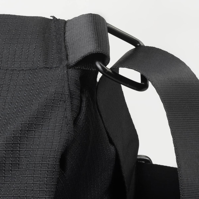 A black sling bag featuring a durable fabric and metal hardware for strap adjustment. It has a logo.