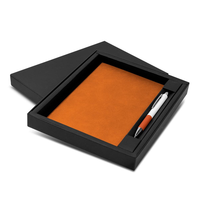 An orange notebook with a black cover and an orange and white pen, presented in a black gift box.