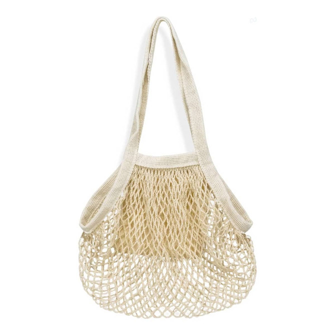 A small cotton mesh tote bag in cream colour with a spacious woven design and single shoulder strap.
