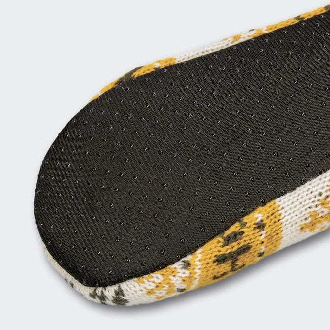 A pair of custom knitted slippers featuring a patterned upper in yellow and white with a black textured sole.