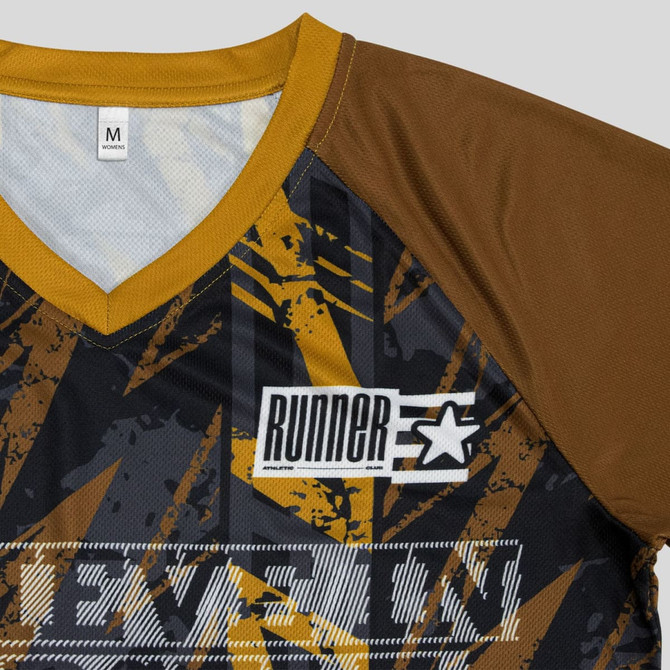 A custom women's active V-neck T-shirt featuring a mix of black, gold, and grey patterns, with a logo.