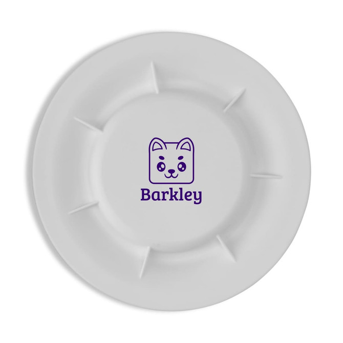 A white pet food plate featuring a cute dog design and a logo in dark purple.