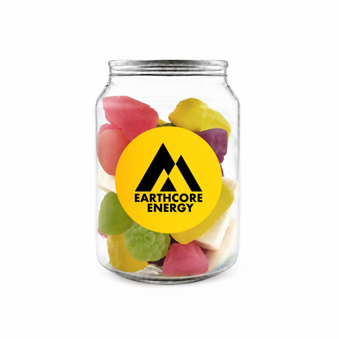 A clear jar contains a colourful mix of jelly sweets in various shapes, featuring a prominent logo on the front.