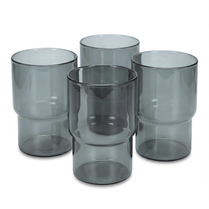 A set of four grey-tinted tumblers with a modern design, featuring varied shapes and a glossy finish.