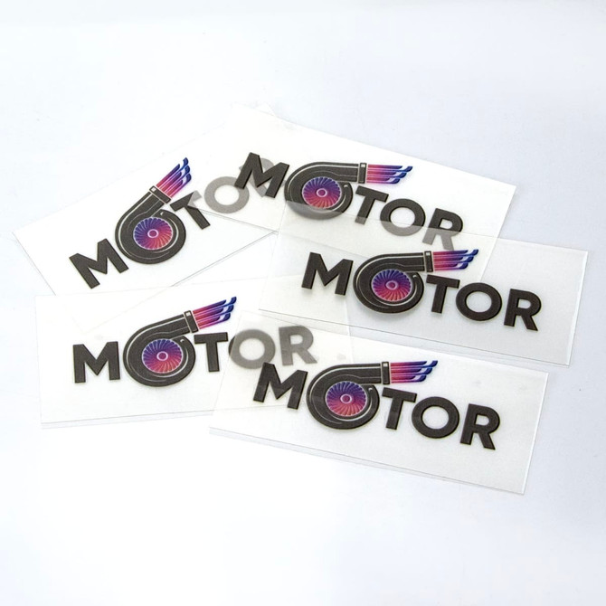 A collection of stickers featuring the word "MOTOR" with a logo, primarily in black and vibrant colours.