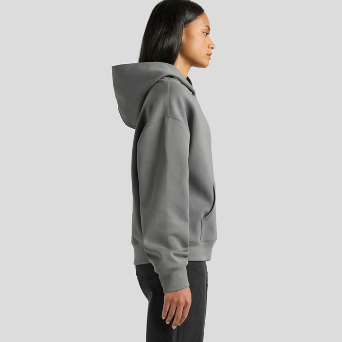 A grey hoodie with a spacious hood, featuring a side view of a woman wearing it. It has a logo on the front.