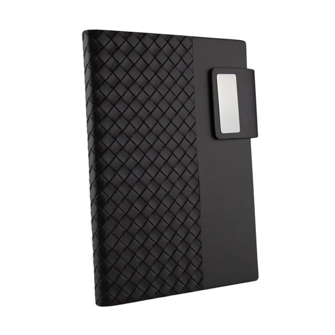 A black Nexus Notebook with a textured, woven cover and a detachable clip for securing pages.