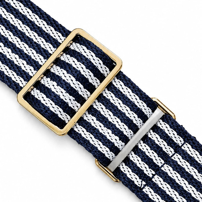 A navy and white striped fabric strap with a gold and silver buckle. The strap features woven textile material.