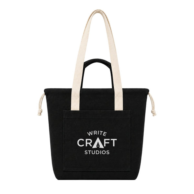 A black tote bag with cream straps and a front pocket, featuring a logo on the surface.