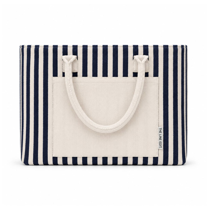 A striped tote bag in navy and cream, featuring two handles and a front pocket, with a logo.
