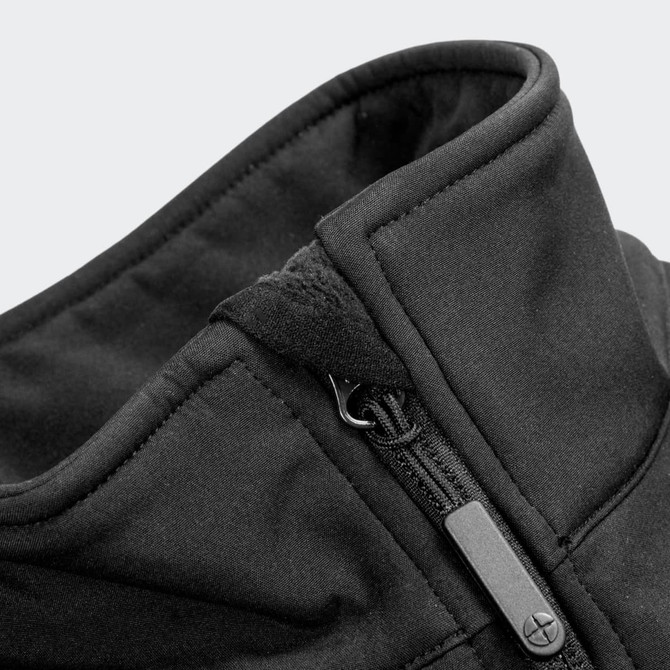 A close-up of a zipped collar on a black softshell jacket featuring a smooth fabric and a zipper pull.