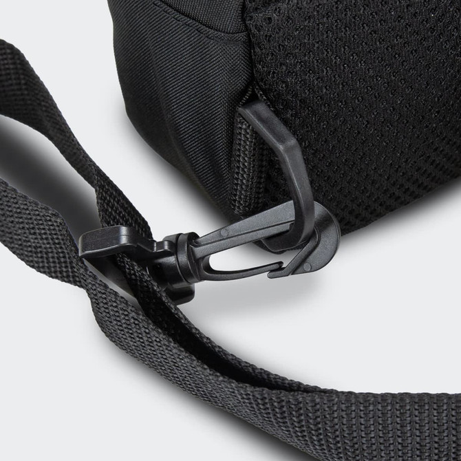 A black crossbody bag featuring a textured strap and a clip attachment. It has branding on the bag.