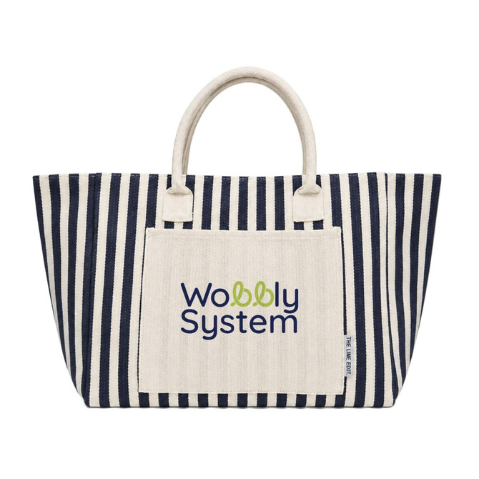 A striped tote bag in navy and cream with a logo on the front. The bag features two sturdy handles.