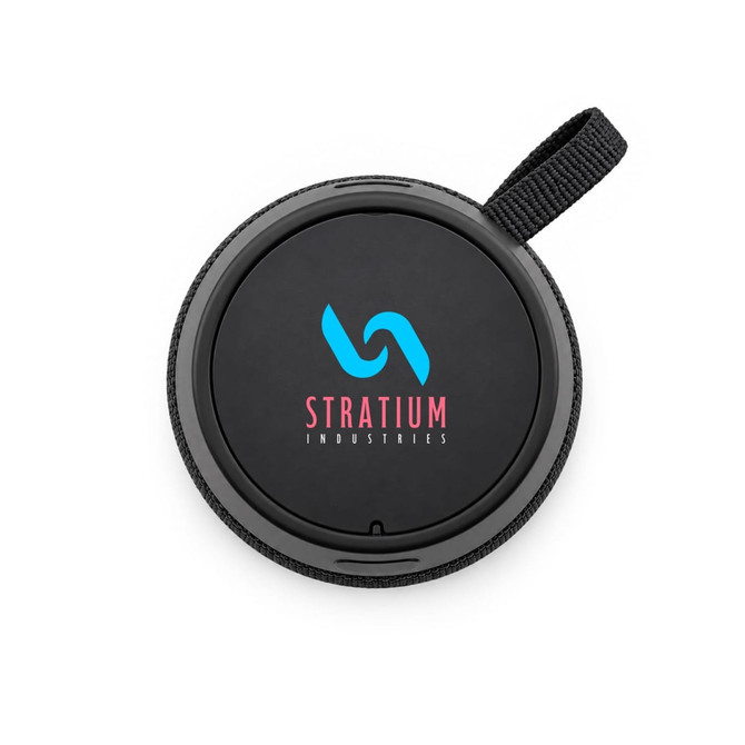 A round black speaker featuring a woven strap and a logo in blue and pink on the top surface.