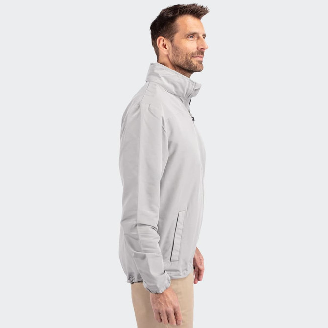A light grey men’s full zip jacket, featuring a stand-up collar and side pockets. The jacket has a branding logo.