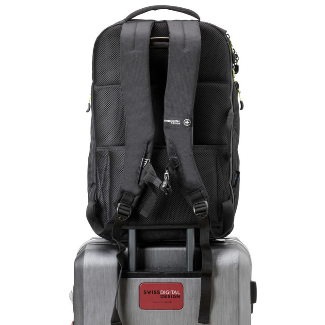 A black Swiss Digital Java Backpack is positioned on top of a silver suitcase. The backpack has a branding logo.