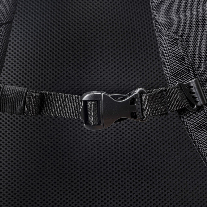 A close-up of a black backpack strap featuring a plastic buckle and mesh detailing. The backpack has a logo.